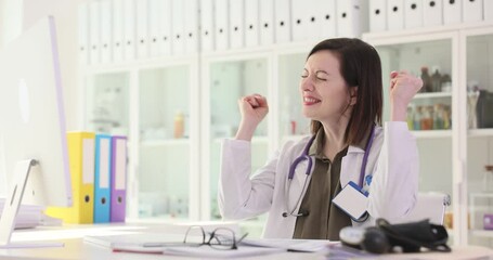 Woman doctor rejoicing at good patient test results in paper documents 4k movie slow motion. Positive mood of doctors concept