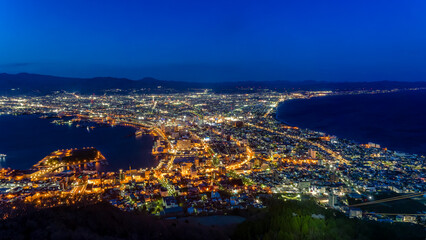 A coastal city illuminated by lights during the Blue Hour (Hakodate, Hokkaido)