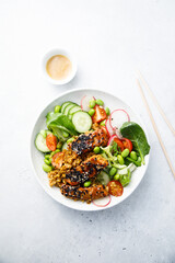 Salmon poke with vegetables and sesame seeds