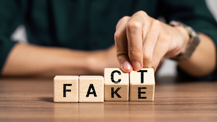Fact or Fake concept, Hand flip wood cube change the word, April fools day - obrazy, fototapety, plakaty