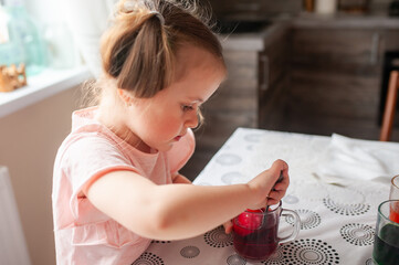 A smile girl paints Easter eggs. - 750500868