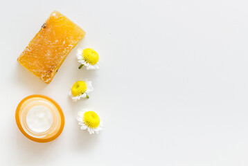 Chamomile flowers and herbs with face cream and organic soap