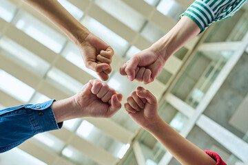 Group of people doing knuckle touch. Teamwork concept.