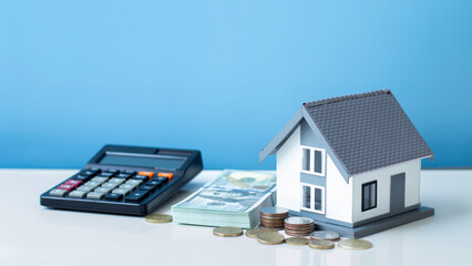 Property tax.investment planning.business real estate. View Of coin stack with house model,...