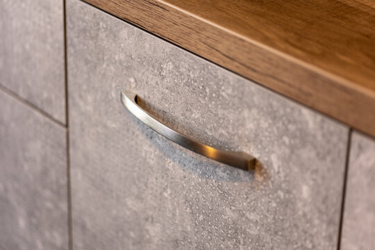 Metal handle close up photo on a chest of drawers