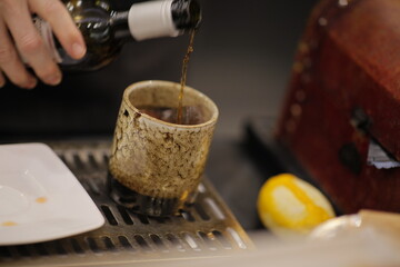 Close up on the making of artisanal cocktail, depth of field is very shallow for selective focus.