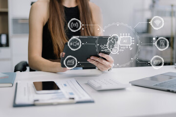 Business woman using a smartphone and laptop computer chatting with an intelligent artificial intelligence.