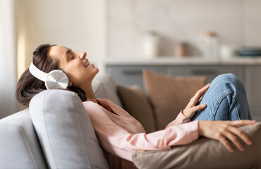 Woman relaxing with music on headphones, enjoying downtime