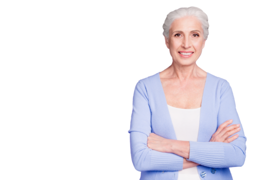 Portrait of confident elderly woman looking at camera with arms crossed on chest isolated on shine purple violet background with copy space for text