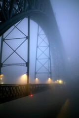 Dom Luis I Iron Bridge at night in thick milky fog, Porto, Portugal.