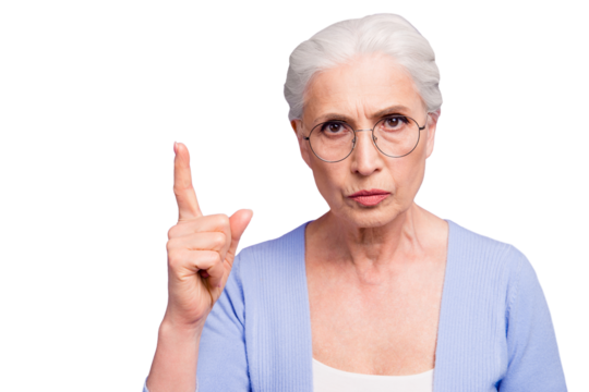 Portrait of grey haired old strict woman wearing glasses pointing up threatening with finger. Isolated over violet purple background