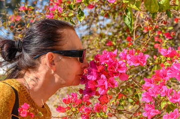 woman smelling bougainvillea flowers in cyprus 5