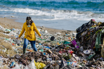 Activist with gas mask standing on landfill, large pile of waste by sea, shoreline. environmental...