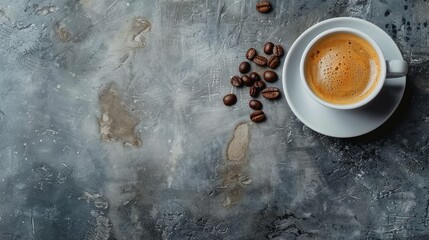Top view of a freshly brewed espresso in a white cup with scattered coffee beans on a gray surface. - obrazy, fototapety, plakaty