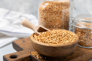 Green buckwheat in a bowl on a wooden kitchen table.Superfood.Raw buckwheat porridge.Healthy vegan food concept, eco products, diet. Copy space.Organic food.weight loss and proper nutrition.