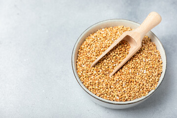 Green buckwheat in a bowl on a wooden kitchen table.Superfood.Raw buckwheat porridge.Healthy vegan food concept, eco products, diet. Copy space.Organic food.weight loss and proper nutrition.