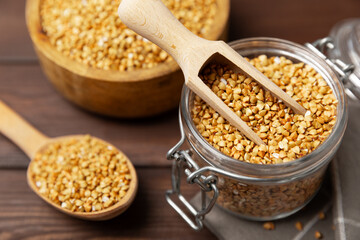 Green buckwheat in a bowl on a wooden kitchen table.Superfood.Raw buckwheat porridge.Healthy vegan food concept, eco products, diet. Copy space.Organic food.weight loss and proper nutrition.
