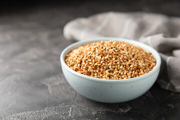 Green buckwheat in a bowl on a wooden kitchen table.Superfood.Raw buckwheat porridge.Healthy vegan food concept, eco products, diet. Copy space.Organic food.weight loss and proper nutrition.