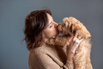 girl kisses her dog, taking care of pets
