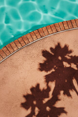 Summer background with swimming pool water in shade. Top view.