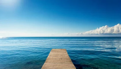 Gordijnen clean blue sky above a blue surface of the sea © Wayne