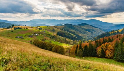 Fototapeta na wymiar rolling hills of mountainous countryside landscape scenery of carpathian rural area in autumn season on an overcast day village in the valley