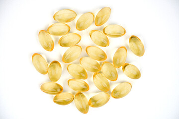 Golden color oil supplements isolated on white background