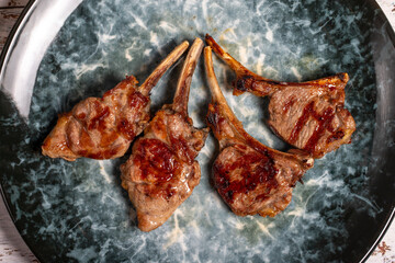 Freshly grilled lamb chops. Slices of cooked lamb chops on wood background. high quality photo. Top...