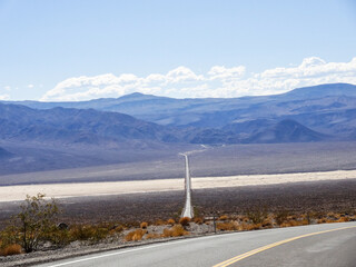 Death Valley long straight road throug Valley. Salt desert