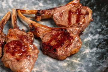 Freshly grilled lamb chops. Slices of cooked lamb chops on wood background. high quality photo. Close up