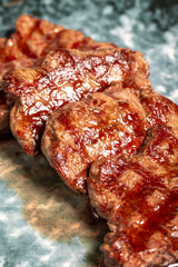 Freshly grilled beef tenderloin slices. Slices of cooked tenderloin on wood background. high quality photo. Close up
