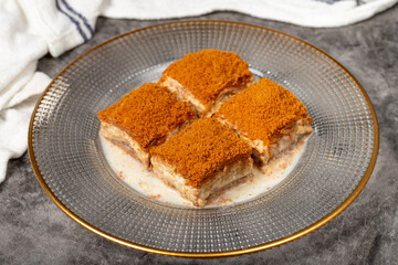 Cold baklava with biscuits. Cold baklava with biscuit filling on a dark background. local name lotuslu soğuk baklava. Close up