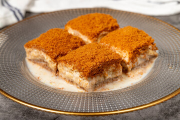 Cold baklava with biscuits. Cold baklava with biscuit filling on a dark background. local name lotuslu soğuk baklava. Close up