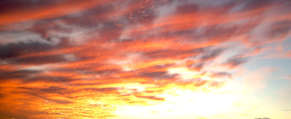 Sunrise background. Dramatic majestic scenery sunset. Sky with clouds in Sunrise sky light...