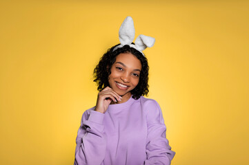 Copy space easter banner with happy smiling sfrican american girl in eater bunny ears. Studio shot. Place for text