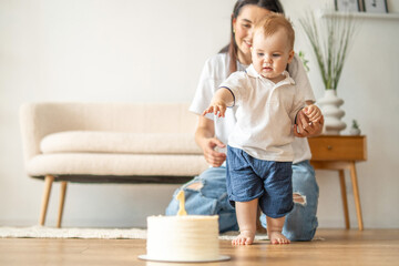 Obraz premium Woman and Baby Playing With Cake