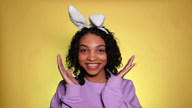 easter studio footage with cute surprised girl in bunny ears happy screaming. advertisment and promotion concept