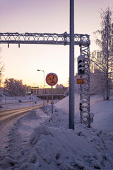 Highway entrance traffic signal covered in snow on a winter scene in Rovaniemi, Finnish Lapland
