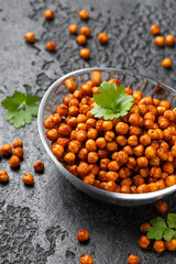 Roasted spicy chickpeas in bowl. Healthy snack.
