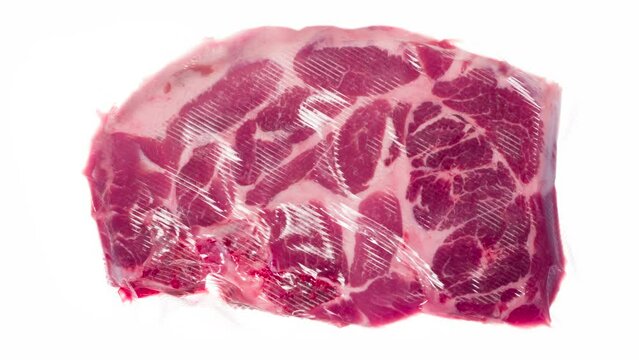 Packaging and Freezing Beef Steak. Fresh marbled beef steak is packaged in a vacuum apparatus and subjected to rapid cooling with an ice jet, creating the effect of white steam on a white background