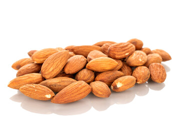 Several roasted almonds, macro, isolated on white background.