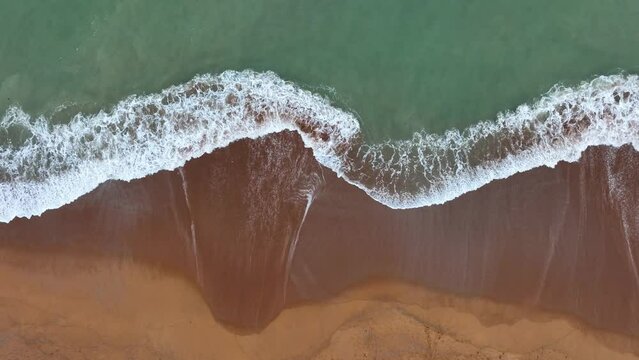 The soft wave water of the sea on the sandy beach background