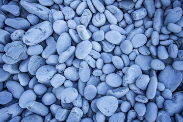 Beach made of stones, sea pebbles, close-up view. Natural backgrounds - obrazy, fototapety, plakaty