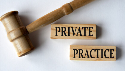 PRIVATE PRACTICE - words on wooden blocks on a white background with a judge's gavel.
