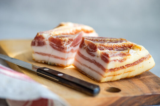 Thick slices of raw lard on a wooden board