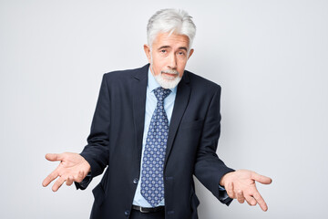 Confused businessman shrugging, uncertainty concept
