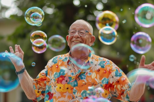 A senior man exudes happiness in a vibrant floral shirt, his face lighting up with a warm smile as he is surrounded by a magical display of colorful soap bubbles.