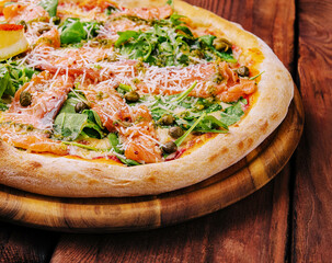 Italian Pizza with salmon, arugula and capers