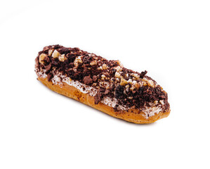 eclair with chocolate and nuts on a white