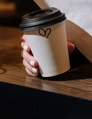 Woman holding a mug of coffee close up